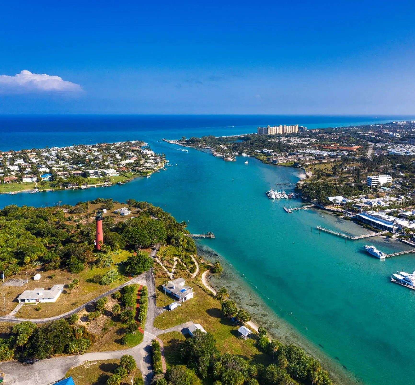 Aerial view of Jupiter's inlet, lighthouse, and coastal neighborhoods