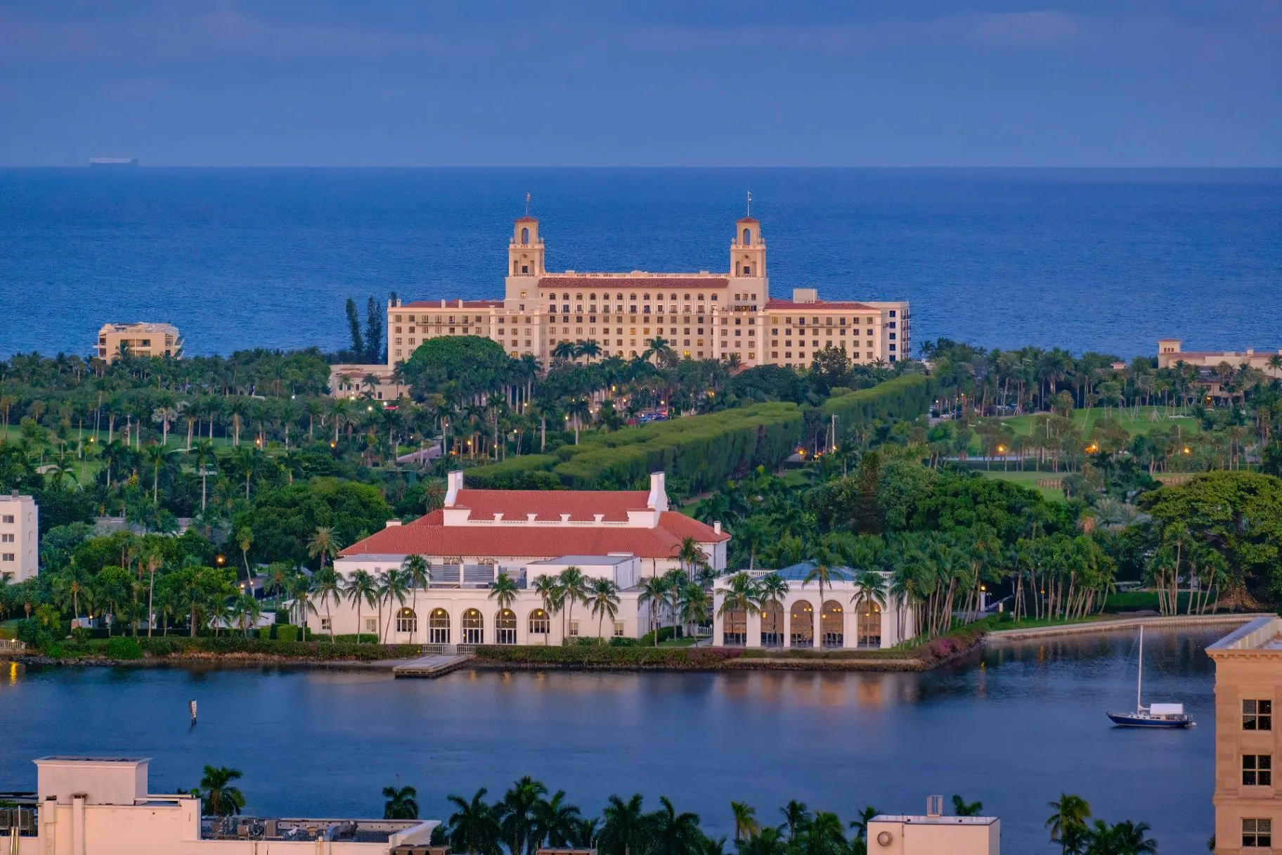 Palm Beach waterfront architecture framed by palms at blue hour