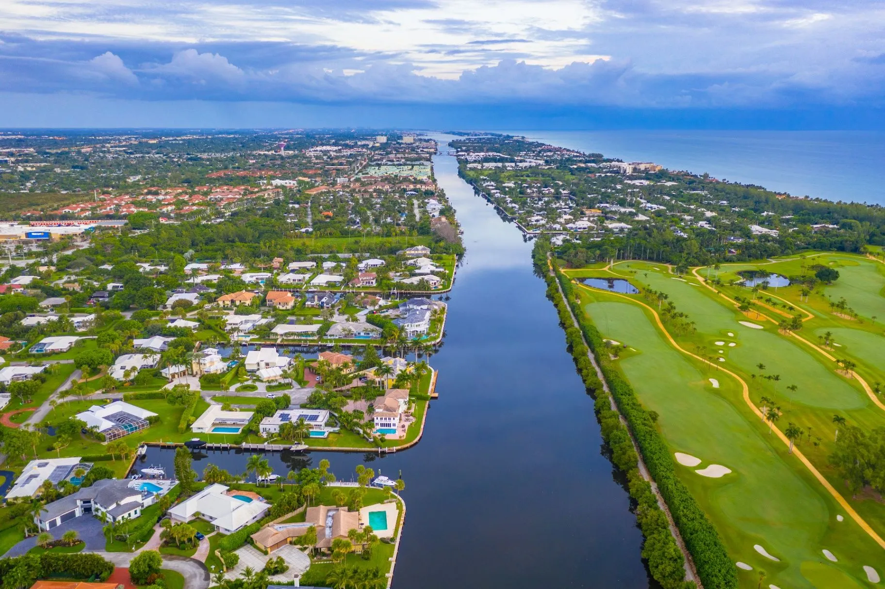 Aerial view of a Palm Beach County neighborhood beside a winding waterway