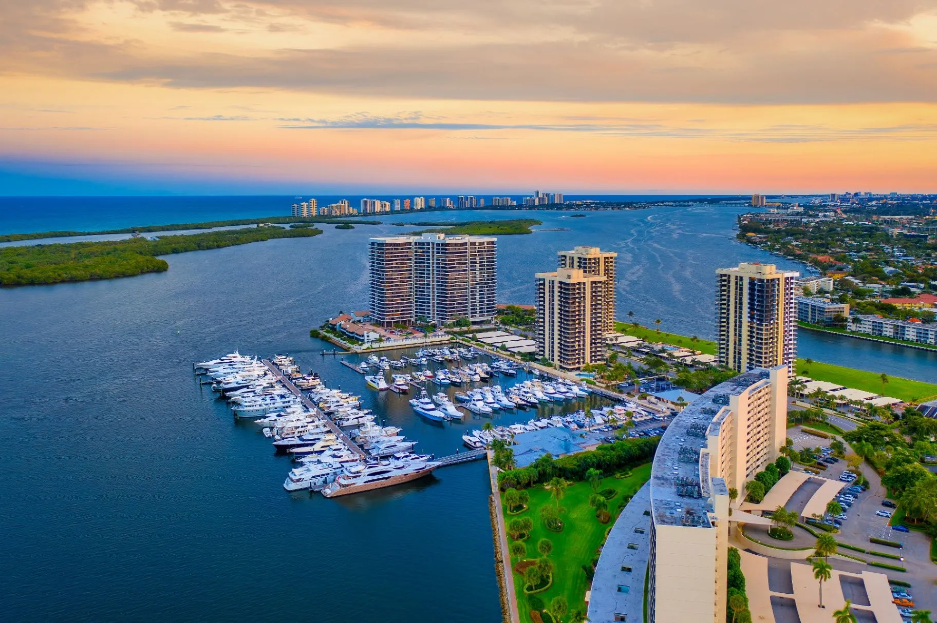 Palm Beach County marina, waterfront towers, and a pastel sky at dusk